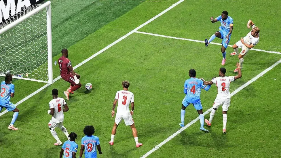 Lionel Mpasi blocks a goalbound shot from Harry Kane