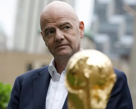 The Fifa president, Gianni Infantino, poses with the World Cup trophy at Radio City in New York.